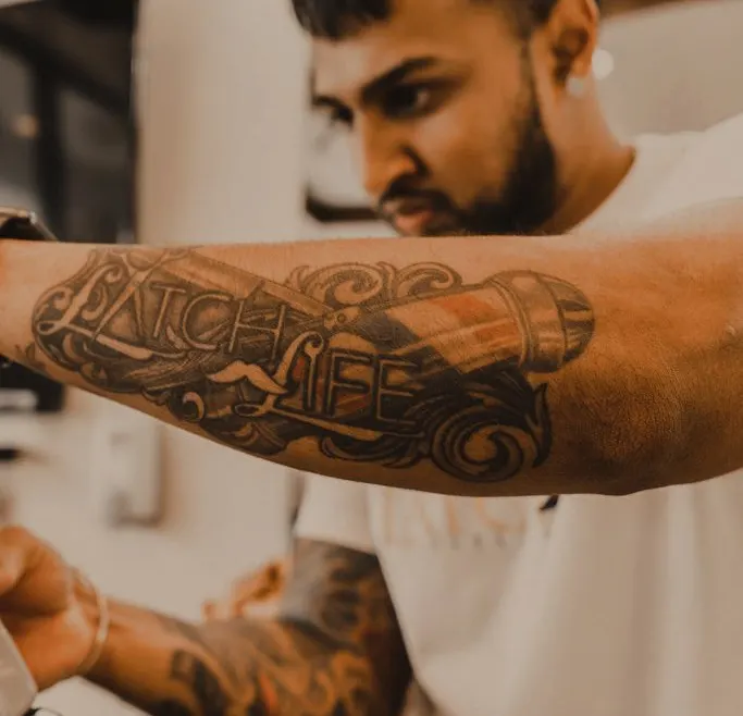 Chris Latch's forearm tattoo reading Latch Life